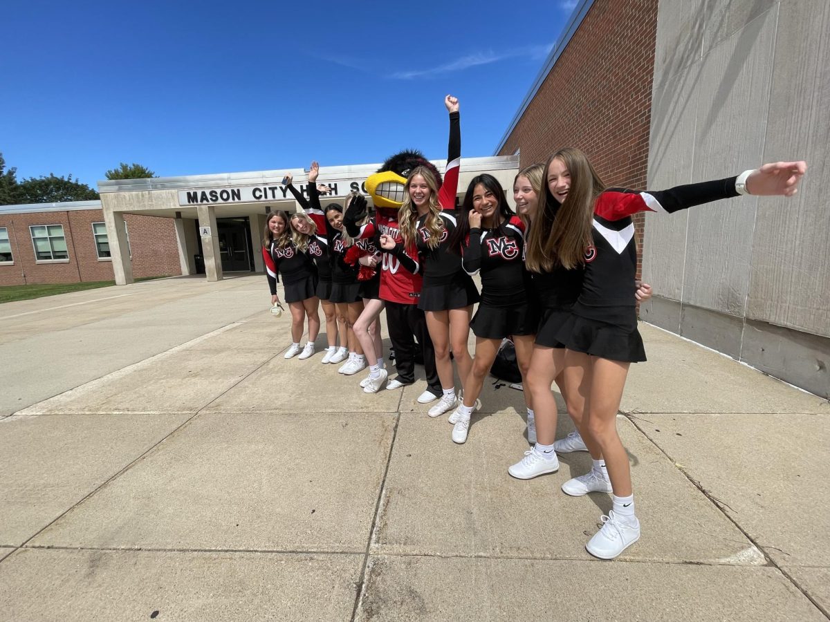 Come on in, Riverhawks! Cheerleaders stand outside the front entrance of MCHS. Reaching high school is a momentous milestone. Senior Autumn Overland has advice.