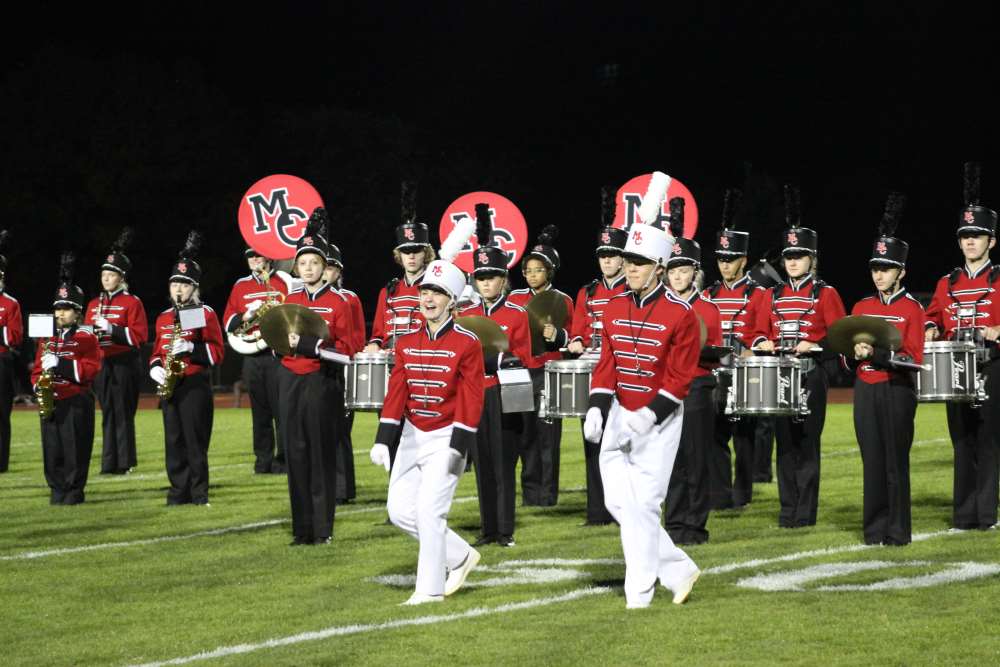 Drum Majors Hannah Jacobs (senior) and Michael Johnson (junior) lead the MCHS Marching Band onto the field for their Homecoming 2024 performance.