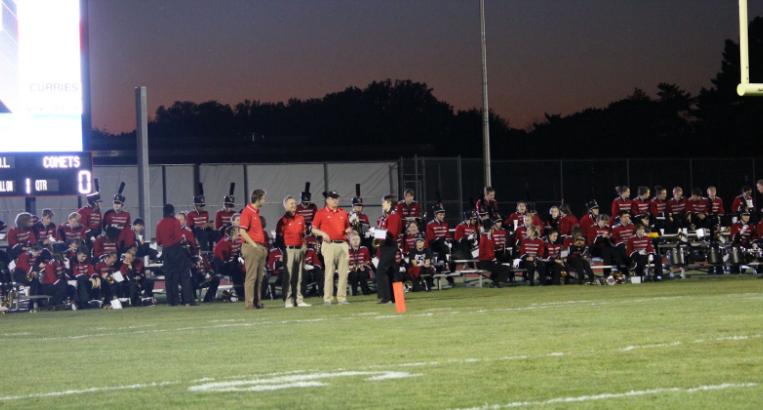 The Riverhawk marching band at the bleachers behind the endzone.