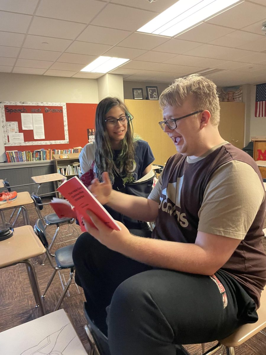 Parker Fredrickson(12) and Kylie Gutierrez(12) rehearsing their script out of the play book.