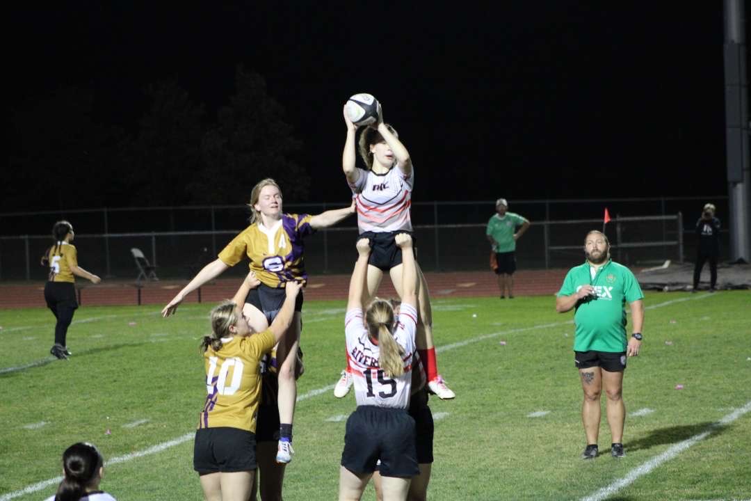 Sophomore Maddie Cornish is lifted up to receive the ball after a line-out. During a line-out two players from opposing teams are lifted into the air while the hooker throws the ball back into play after the ball goes out of bounds.