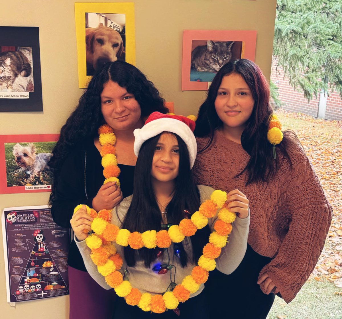 Rachel Dominguez-Nava (left), Angel Victoriano (Right), and Leilani Freeman (middle) are taking down their decorations as Latino Heritage Month comes to a close.