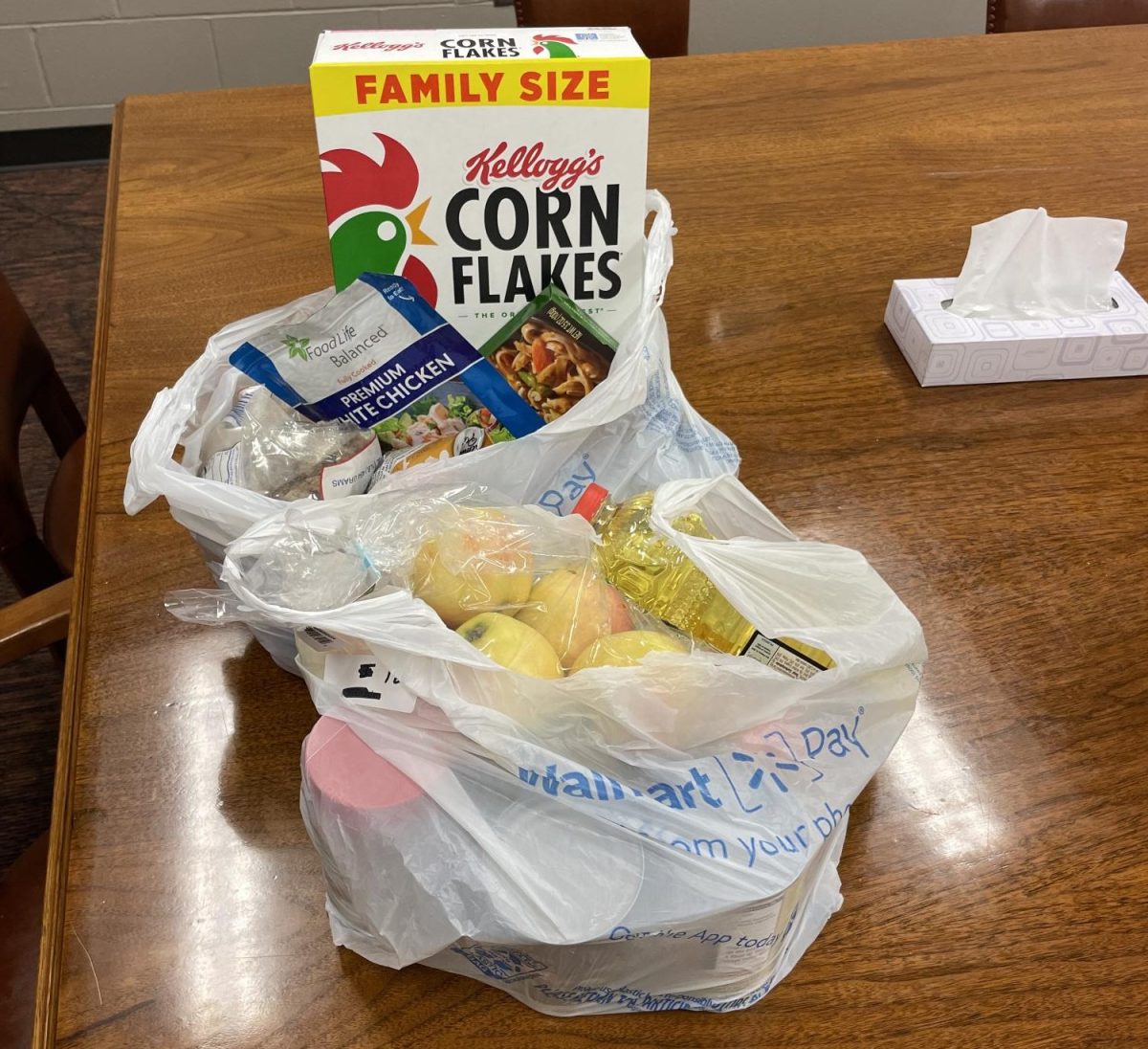 A student's order containing produce, canned goods, and other foods that they will bring home for their family.