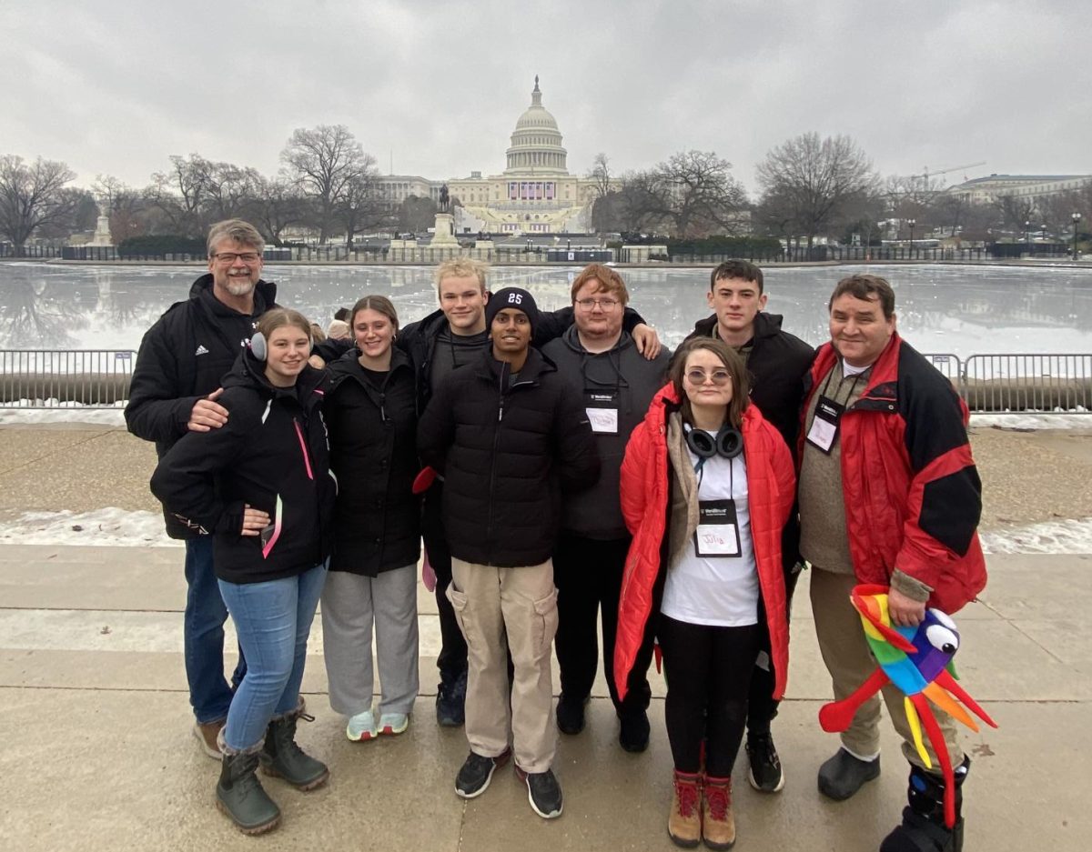 L to R: Mr. John Lee, Chloe Broers, Olivia Wickman, Ryan Hinson, Johnathan Thangaraj, Mikey Sarik Jr., Julia Hines, Brandt Haakenstad, and Mr. Jeff Hines stand in front of the Capital Building. Photo courtesy of Olivia Wickman. 