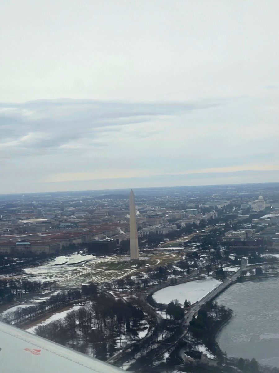 While landing at Ronald Reagan Washington National Airport, senior Ryan Hinson snaps an aerial photo of the National Monument. The students flew into the nation's capitol early Saturday morning to witness the historic transfer of power  from President Joe Biden to President-Elect Donald J. Trump. The ceremony takes place Monday at noon. 