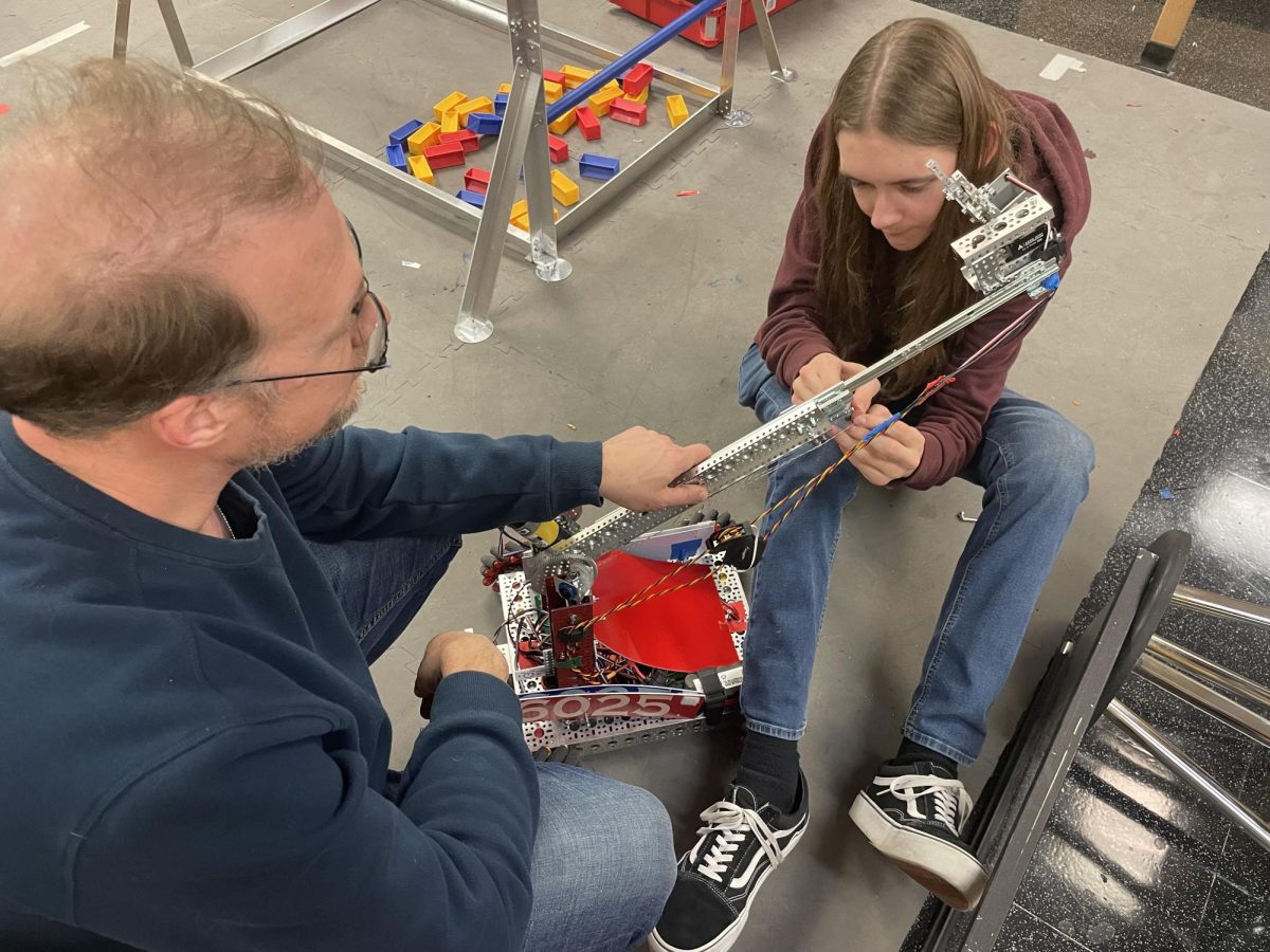 Colin Peterson works out some tweaks in the robot. "How did this happen?" He said. "This is supposed to be wrapped around this way." Peterson uses a computer programming to give the robotics directions. 