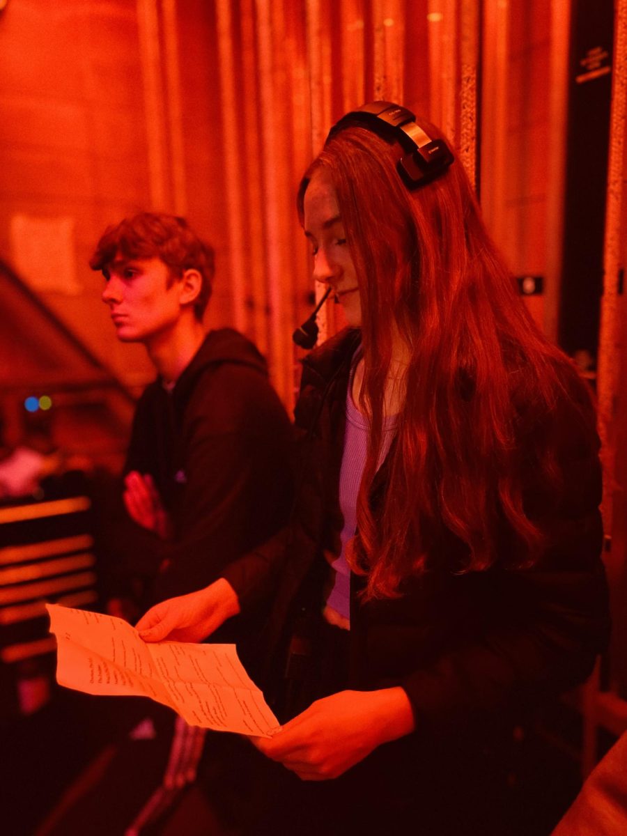 Stage manager Cadence Rish checks the act list backstage during the Follies performance Monday night. 