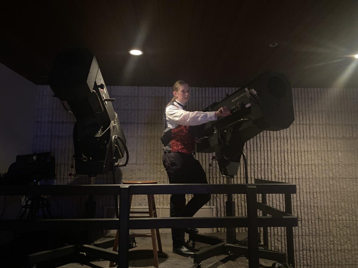 Maxson Case repositions his spotlight during a Follies rehearsal. His job is to make sure all acts are clearly visible to the audience by providing extra lighting. 