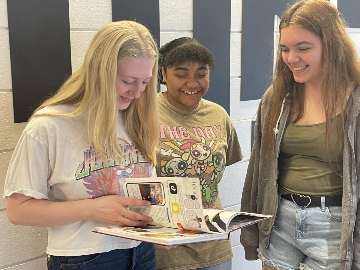 Ashland Ruby, Joseline Hernandez and Jordan Roehl flip through pages of the new Masonian.
