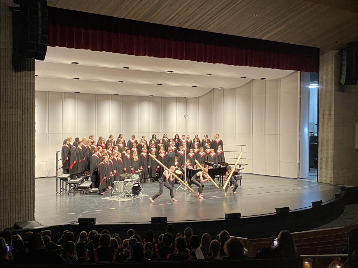 (L to R) Carter Long ('26), Samuel Schwarz ('26), and Jonathan Thangaraj ('25) dance during "Freedom Come" at the choir concert  Tuesday night. 