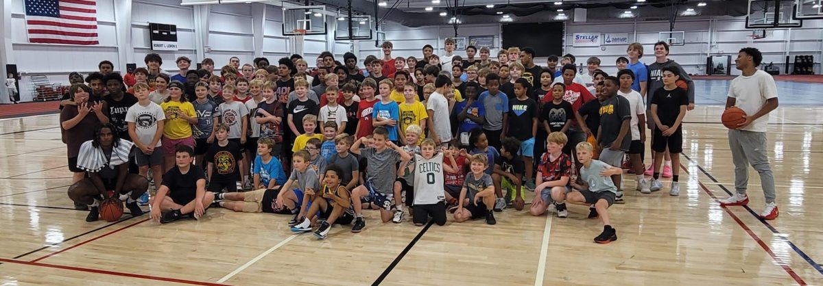 Talons players gdt their picture taken with MCHS Boys Basketball Team which hosted a skills clinic in September.