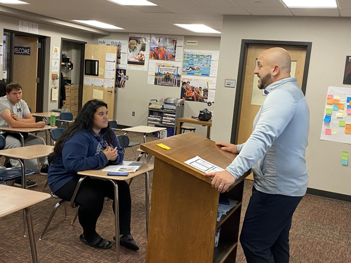 MCHS Associate Principal Christopher Krueger takes questions from journalism students after receiving a prestigious award from the School Administrators of Iowa