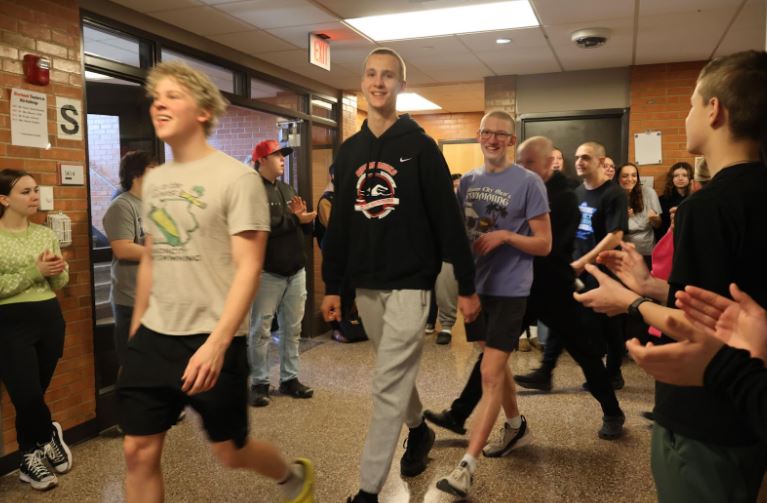 Michael Johnson and Brock Anderson lead the Riverhawk Swim Team as they get a send off to the State Swim Meet from students on Thursday, (Feb. 12)