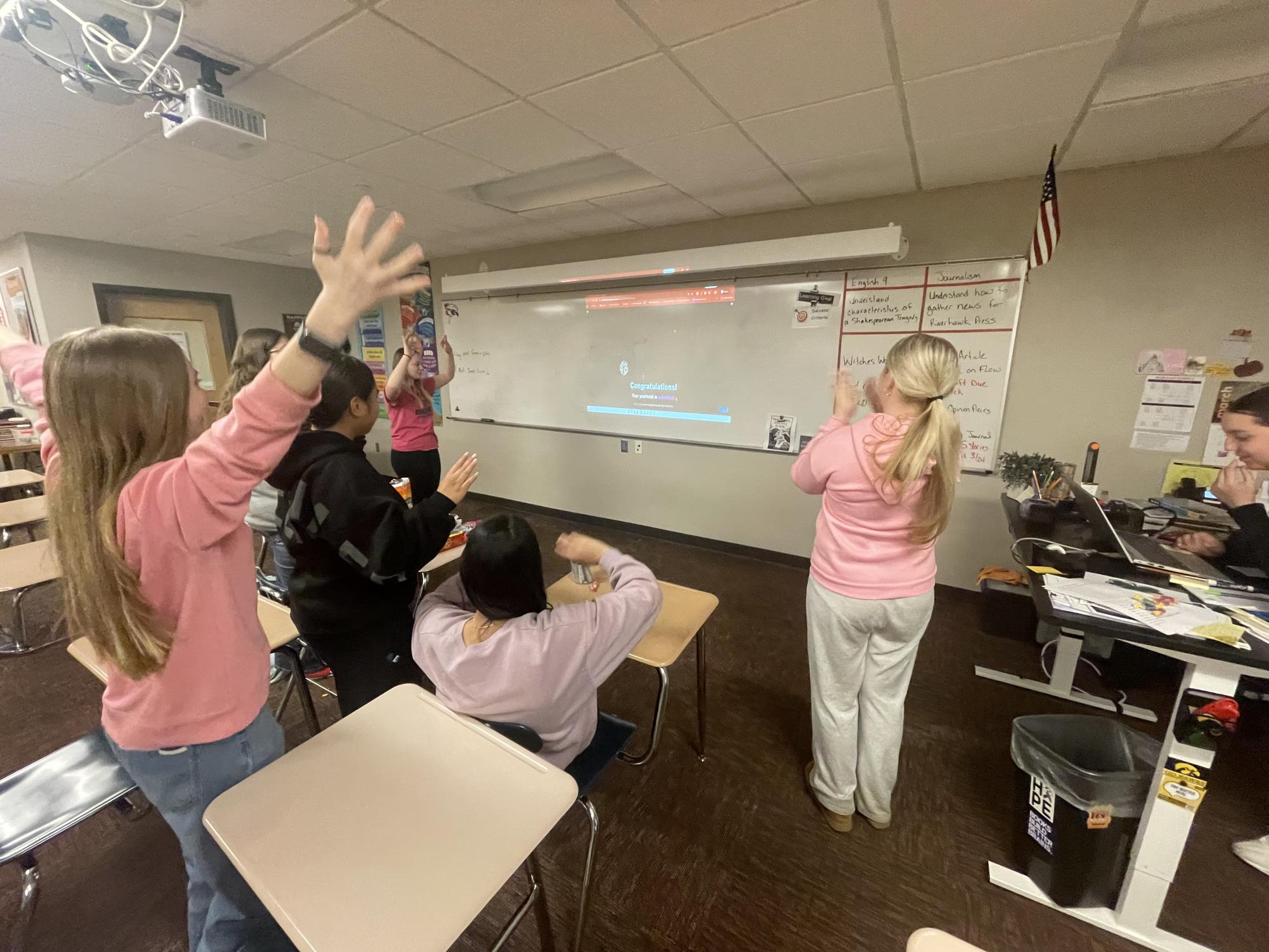 The yearbook staff celebrates submitting its last page to the publisher. Throughout the year, the students design 176 pages covering sports, clubs, and student life. 