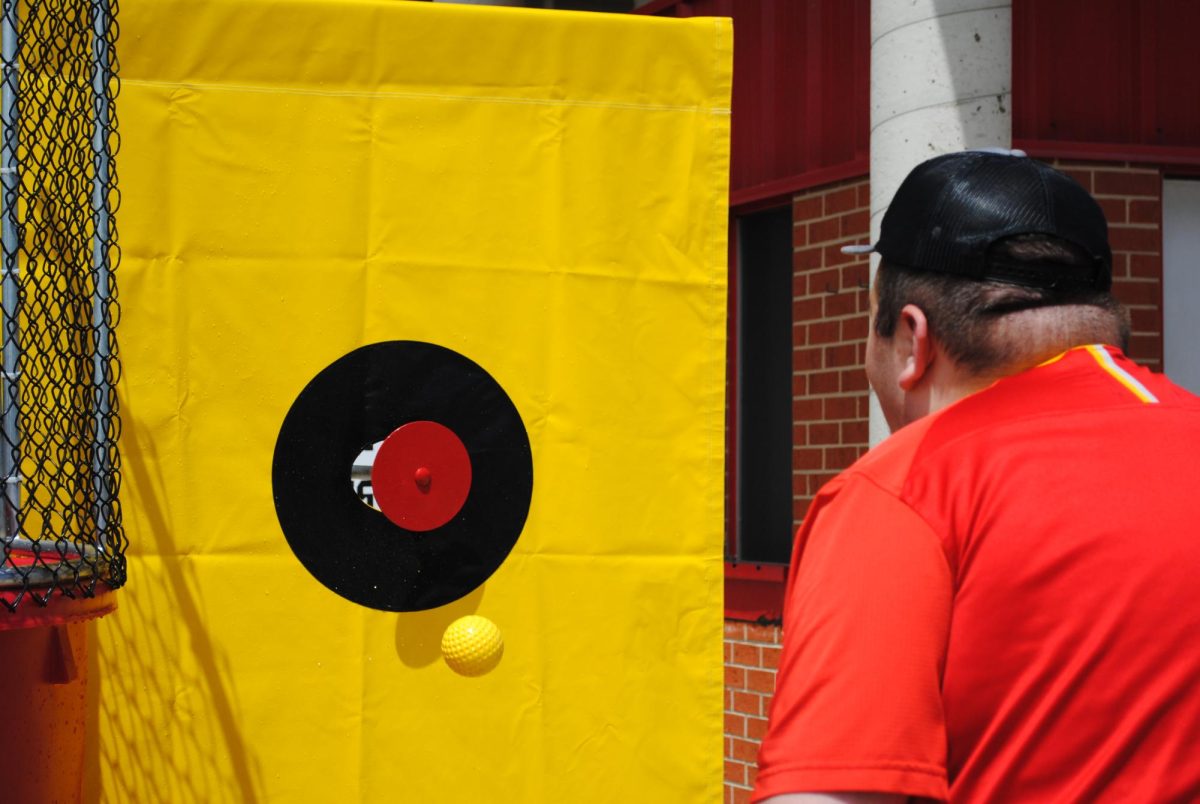 Senior Noah Becker aiming for the bullseye to dunk Principal Dan Long outside the Riverhawk Stadium (May 20, 2026)